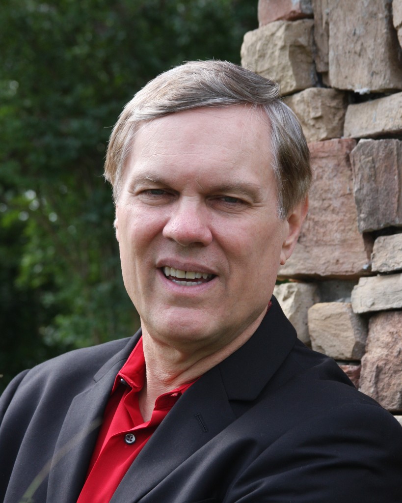 A man in a black jacket and red shirt