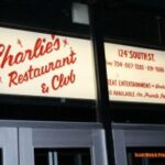 Charlie's Restaurant and Club sign at night.