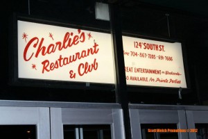 Charlie's Restaurant and Club sign at night.