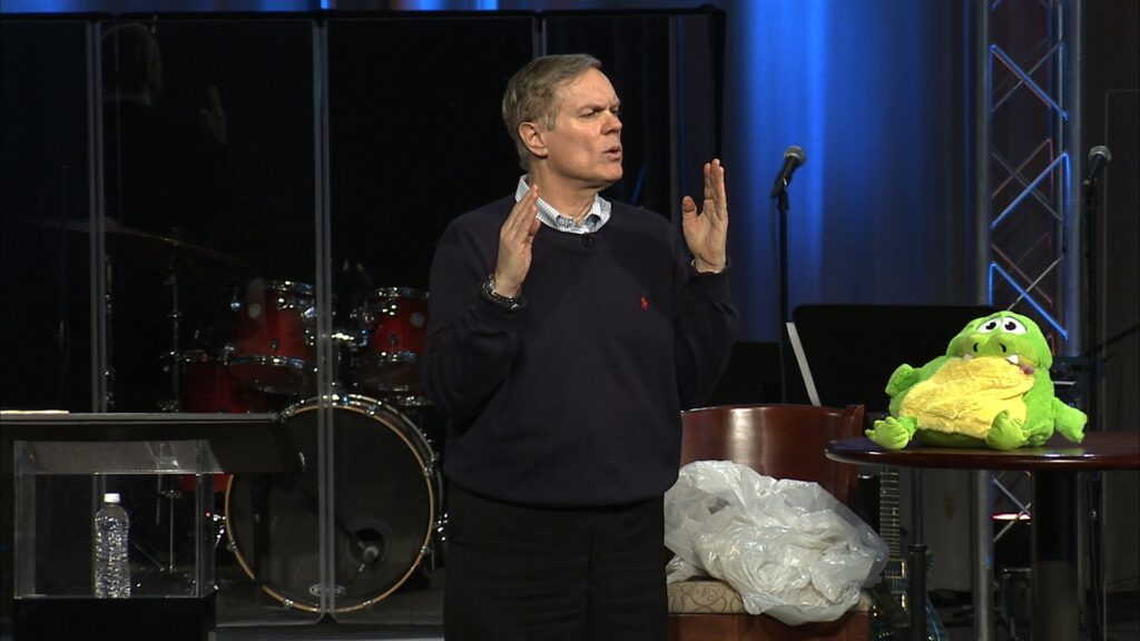 Speaker gesturing while talking onstage.