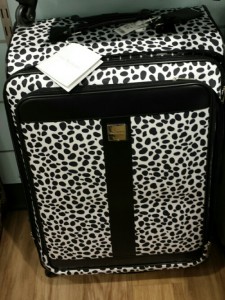 Black and white spotted suitcase on display.