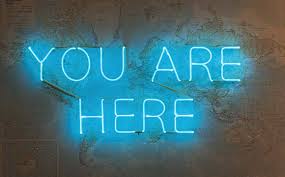 Neon sign saying "You Are Here"