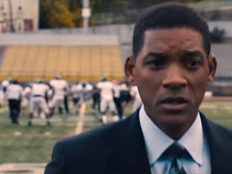 A man in suit and tie standing on top of a field.