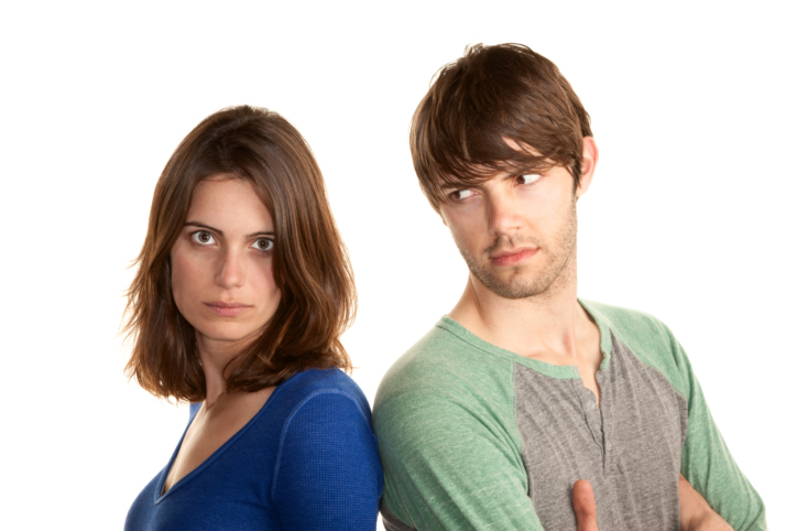 Man and woman standing back to back.