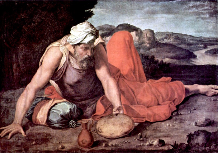 Elderly man in ancient attire by landscape.