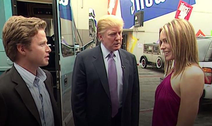 Donald Trump talking with two individuals outdoors.