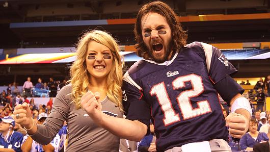 Fans cheering at a football game.