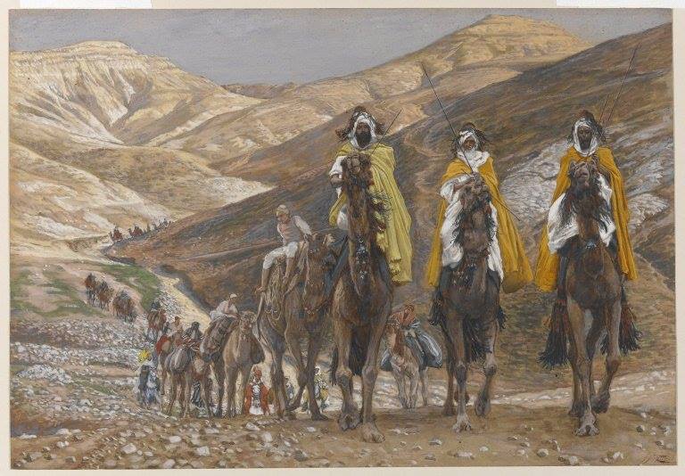 Three riders in yellow cloaks on camels.