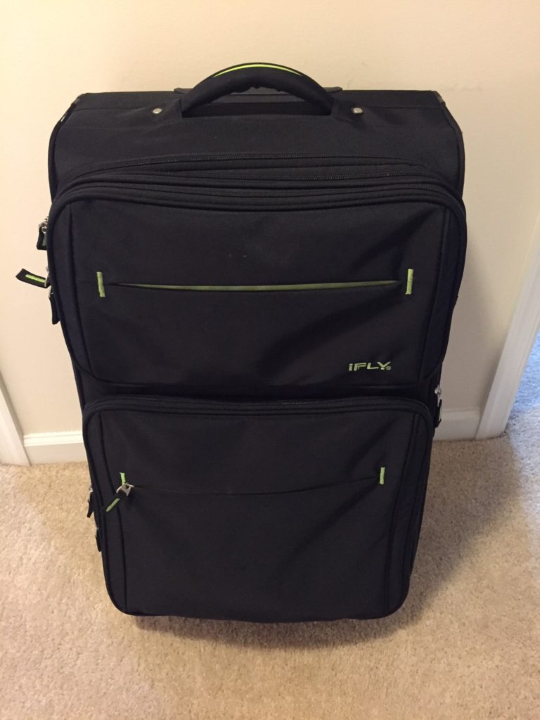 A black suitcase sitting on top of the floor.