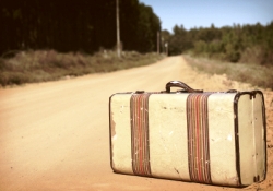 Abandoned suitcase on a dirt road.