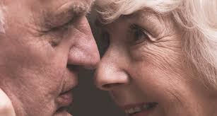 An older man and woman face to face.