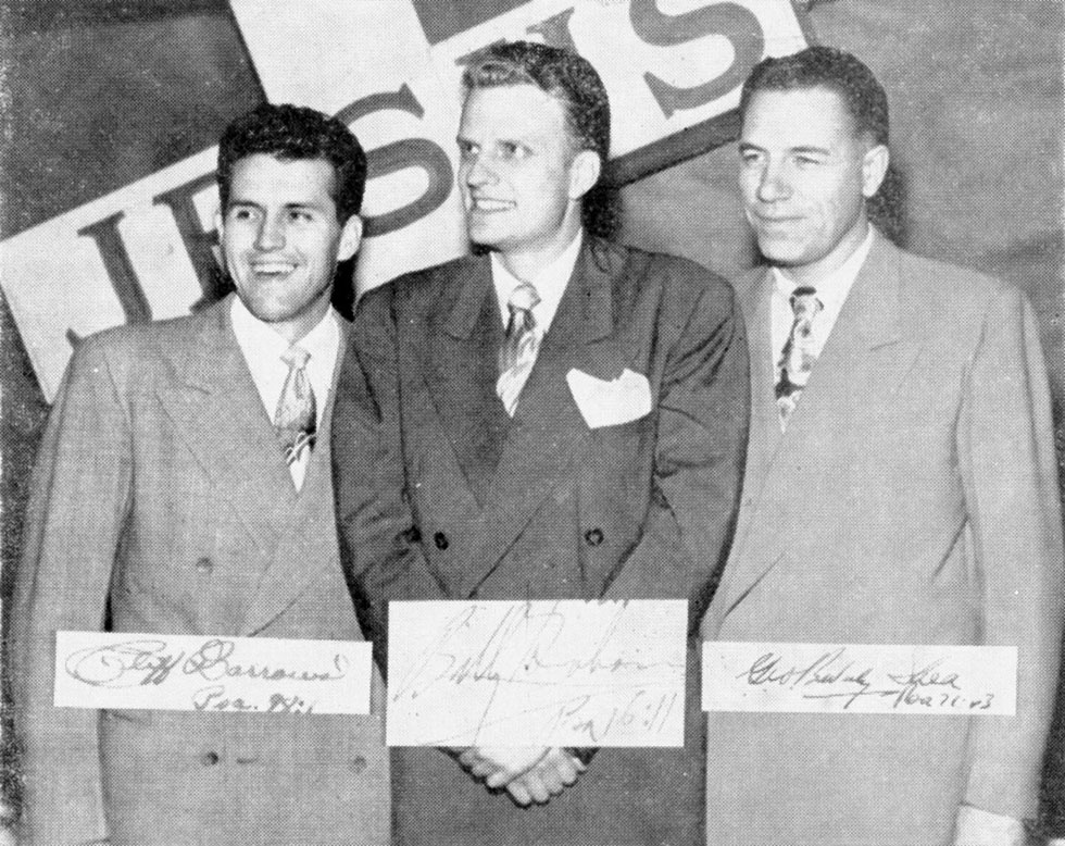 Three men posing with signatures, black and white.