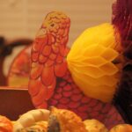 Colorful turkey decoration among autumn gourds.