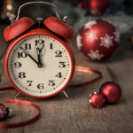 Red alarm clock with Christmas ornaments.