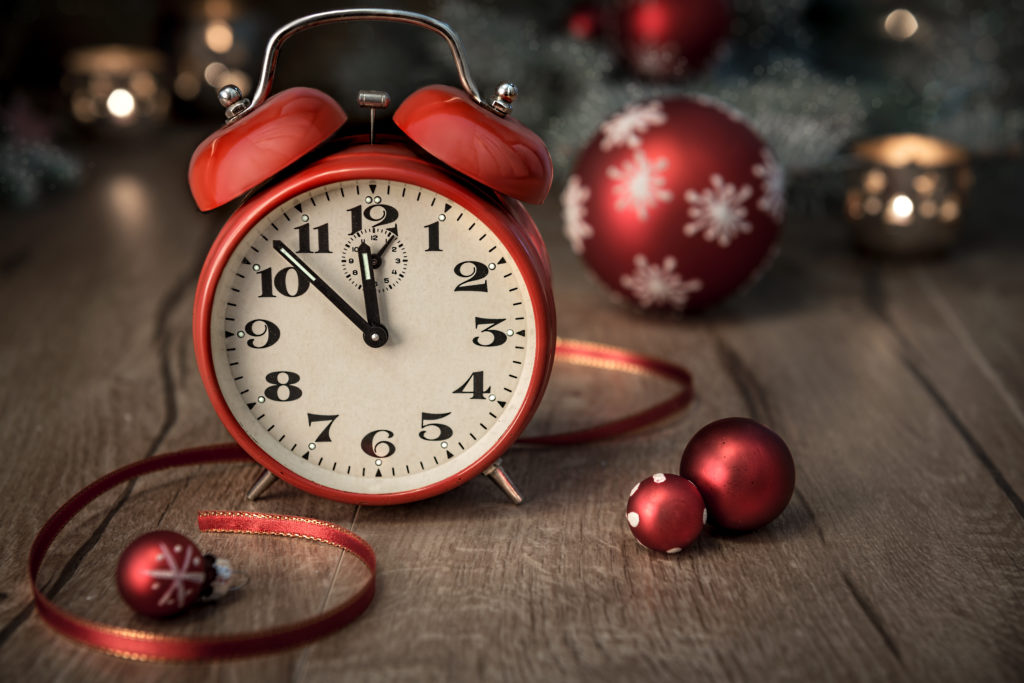 Red alarm clock with Christmas ornaments.