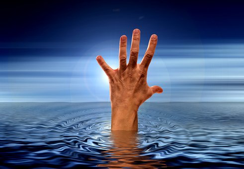 Hand reaching out from water surface.