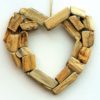 A heart shaped wreath made of wood sticks.