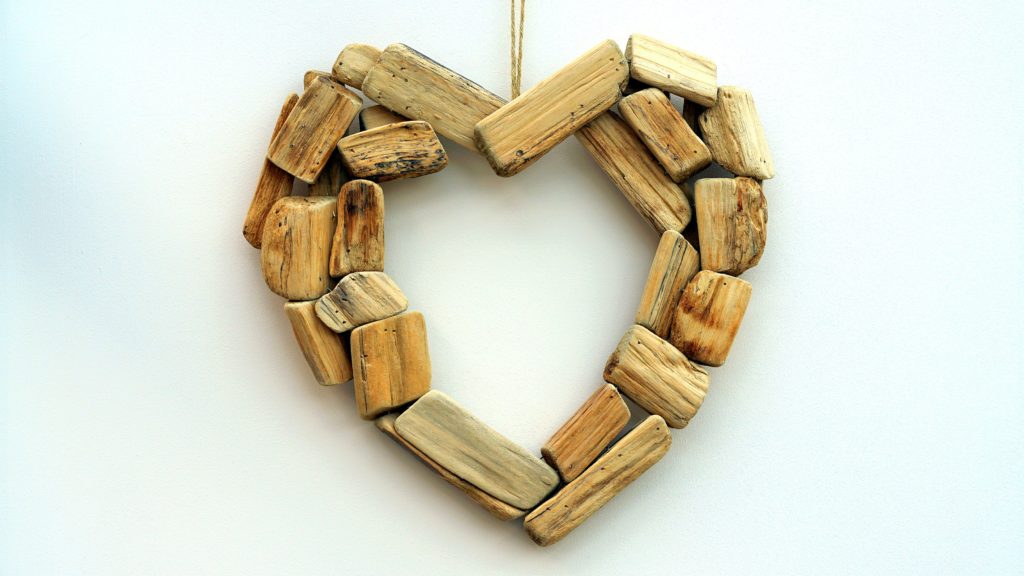 Wooden heart-shaped decoration on white background.