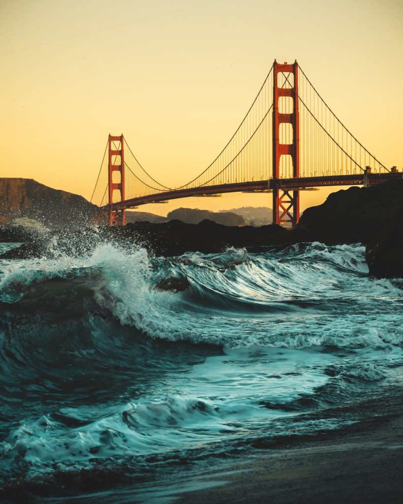 Golden Gate Bridge with ocean waves.