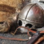 Viking helmet, sword, and leather straps.