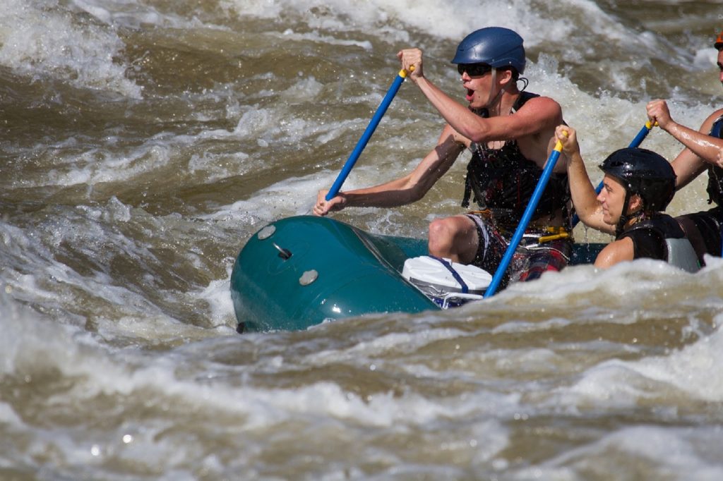 Whitewater rafting team navigating rough waters.