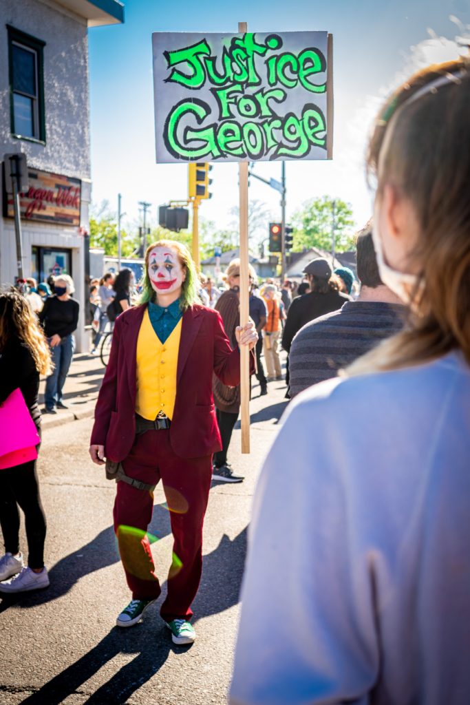 Clown holding "Justice for George" sign.