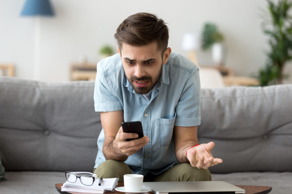 Man looking frustrated at his smartphone.