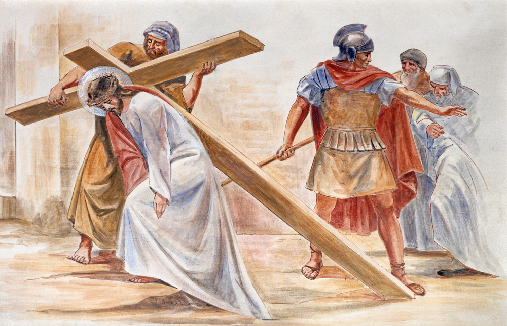 Jesus carrying the cross with onlookers.