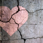 Cracked wall with a heart shape overlay.