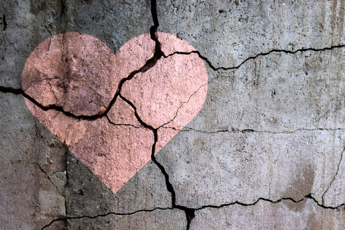 Cracked wall with a heart shape overlay.