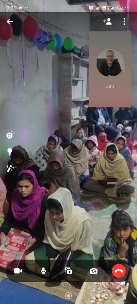 A group of people sitting on the ground.